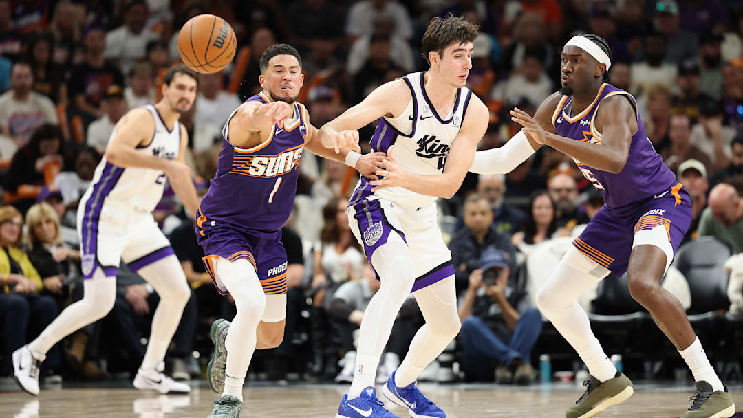 Phoenix Suns teammates Devin Booker and Mark Williams play defense during a game against the Sacramento Kings.