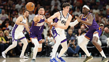 Phoenix Suns teammates Devin Booker and Mark Williams play defense during a game against the Sacramento Kings.