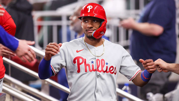 Jun 27, 2025; Atlanta, Georgia, USA; Philadelphia Phillies center fielder Johan Rojas (23) celebrates with teammates after scoring a run against the Atlanta Braves in the ninth inning at Truist Park. Mandatory Credit: Brett Davis-Imagn Images
