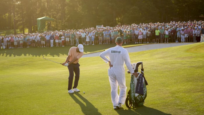 Apr 14, 2024; Augusta, Georgia, USA; Scottie Scheffler hits onto the No. 18 green during the final