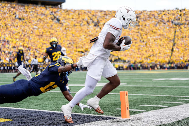 Texas wide receiver Matthew Golden scores a touchdown against Michigan defensive back Aamir Hall.