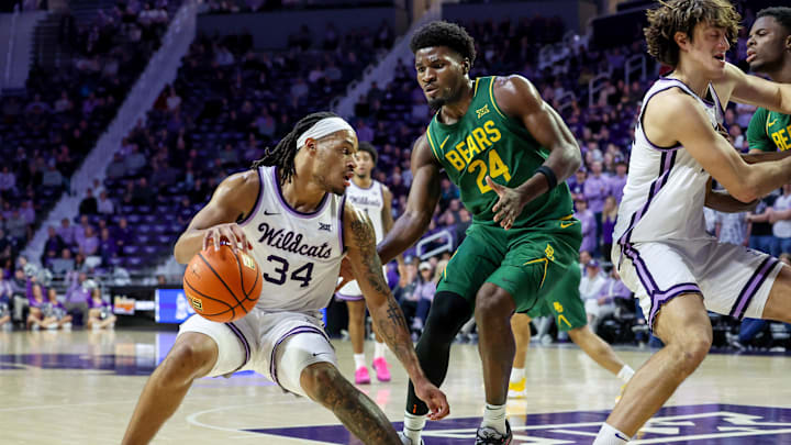Feb 17, 2026; Manhattan, Kansas, USA; Kansas State Wildcats guard Nate Johnson (34) dribbles against Baylor Bears center Caden Powell (44) during the first half at Bramlage Coliseum. 