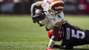 Oct 4, 2025; Cincinnati, Ohio, USA;  Iowa State Cyclones wide receiver Xavier Townsend (4) makes a catch and is tackled by Cincinnati Bearcats safety Christian Harrison (5) in the first half at Nippert Stadium. Mandatory Credit: Aaron Doster-Imagn Images