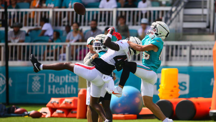 Miami Dolphins wide receiver River Cracraft battles for a pass against Atlanta Falcons cornerback Anthony Johnson during a joint practice at Baptist Health Training Complex.