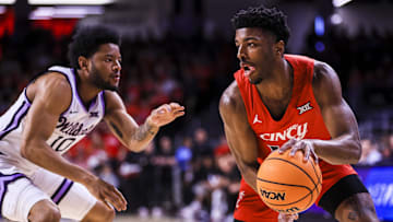 Mar 5, 2025; Cincinnati, Ohio, USA; Cincinnati Bearcats guard Josh Reed (10) dribbles against Kansas State Wildcats guard David Castillo (10) in the first half at Fifth Third Arena. Mandatory Credit: Katie Stratman-Imagn Images