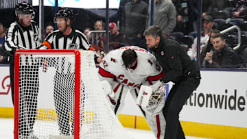 Nov 23, 2024; Columbus, Ohio, USA;  Carolina Hurricanes goaltender Pyotr Kochetkov (52) is tended to by the Hurricanes’ head athletic trainer Doug Bennett during a stop in play in the game against the Columbus Blue Jackets in the overtime period at Nationwide Arena. Mandatory Credit: Aaron Doster-Imagn Images