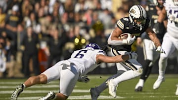 Nov 2, 2024; West Lafayette, Indiana, USA; Purdue Boilermakers wide receiver CJ Smith (9) jukes to avoid tackle from Northwestern Wildcats defensive back Robert Fitzgerald (6) during the second half at Ross-Ade Stadium. Mandatory Credit: Marc Lebryk-Imagn Images