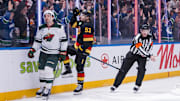Mar 7, 2025; Vancouver, British Columbia, CAN; Minnesota Wild defenseman Brock Faber (7) reacts as Vancouver Canucks forward Teddy Blueger (53) celebrates his goal in the third period at Rogers Arena. Mandatory Credit: Bob Frid-Imagn Images