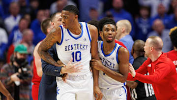 Dec 14, 2024; Lexington, Kentucky, USA; Kentucky Wildcats guard Lamont Butler (1) pushes Kentucky Wildcats forward Brandon Garrison (10) out of the Louisville Cardinals bench area after the teams get together on the sideline during the second half at Rupp Arena at Central Bank Center. Mandatory Credit: Jordan Prather-Imagn Images