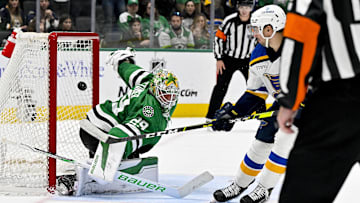 Apr 17, 2024; Dallas, Texas, USA; St. Louis Blues center Jordan Kyrou (25) looks on as his shot hits the crossbar behind Dallas Stars goaltender Jake Oettinger (29) during the overtime shootout at the American Airlines Center. Mandatory Credit: Jerome Miron-Imagn Images