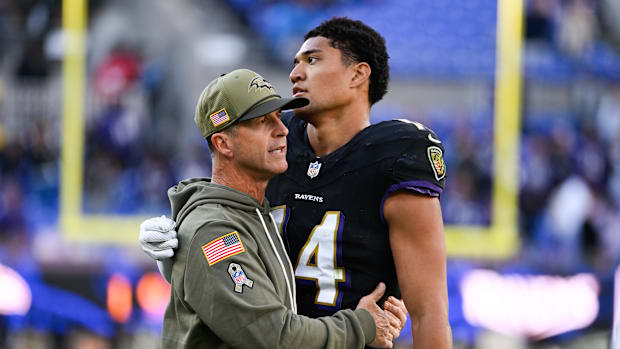 Baltimore Ravens head coach John Harbaugh greets Baltimore Ravens safety Kyle Hamilton 