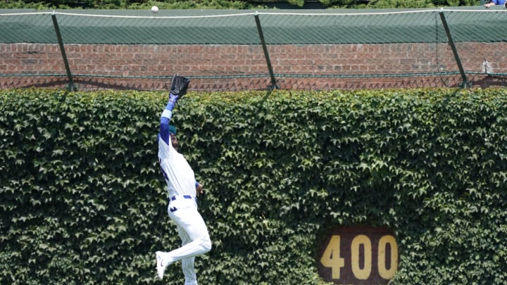 Jun 16, 2024; Chicago, Illinois, USA; Chicago Cubs outfielder Cody Bellinger (24) makes a catch on St. Louis Cardinals second baseman Nolan Gorman (16) during the fifth inning at Wrigley Field. 