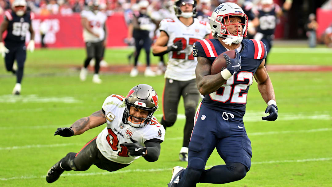 Nov 9, 2025; Tampa, Florida, USA; New England Patriots running back Treveyon Henderson (32) runs for a touchdown past Tampa Bay Buccaneers cornerback Josh Hayes (32) during the third quarter at Raymond James Stadium.