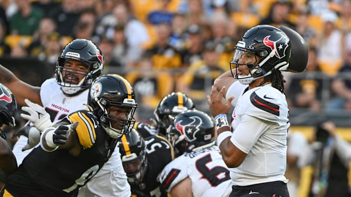 Aug 9, 2024; Pittsburgh, Pennsylvania, USA;  Houston Texans quarterback C.J. Stroud (7) throws a pass while being pressured by Pittsburgh Steelers defensive tackle Keeanu Benton during the first quarter at Acrisure Stadium. Mandatory Credit: Barry Reeger-USA TODAY Sports