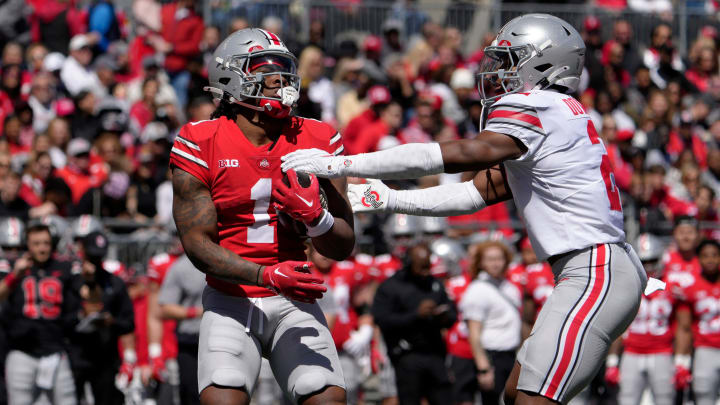 April 13, 2024; Columbus, Ohio, USA; 
Ohio State Buckeyes running back Quinshon Judkins (1) of the scarlet team is tagged by Caleb Downs (2) of the grey team during the first half of the LifeSports spring football game at Ohio Stadium on Saturday.