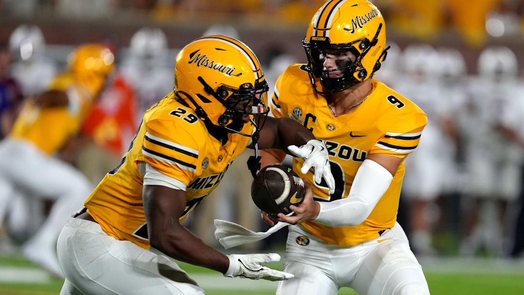Missouri Tigers quarterback Beau Pribula (9) hands off to his running back Ahmad Hardy (29) in a game versus the UMass Minutemen this season.