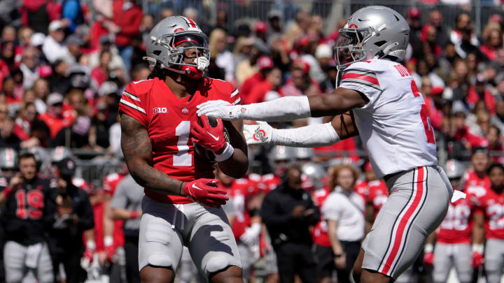 April 13, 2024; Columbus, Ohio, USA; 
Ohio State Buckeyes running back Quinshon Judkins (1) of the scarlet team is tagged by Caleb Downs (2) of the grey team during the first half of the LifeSports spring football game at Ohio Stadium on Saturday.