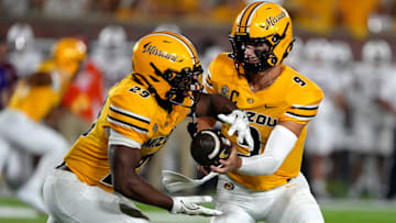 Missouri Tigers quarterback Beau Pribula (9), hands the ball to his running back Ahmad Hardy (29), in a game against the UMass Minutemen this season.