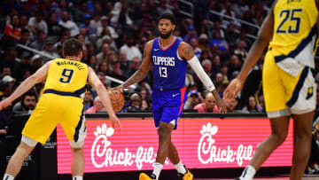 Mar 25, 2024; Los Angeles, California, USA; Los Angeles Clippers forward Paul George (13) moves the ball against Indiana Pacers guard T.J. McConnell (9) during the second half at Crypto.com Arena. Mandatory Credit: Gary A. Vasquez-USA TODAY Sports