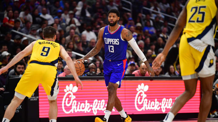 Mar 25, 2024; Los Angeles, California, USA; Los Angeles Clippers forward Paul George (13) moves the ball against Indiana Pacers guard T.J. McConnell (9) during the second half at Crypto.com Arena. Mandatory Credit: Gary A. Vasquez-USA TODAY Sports