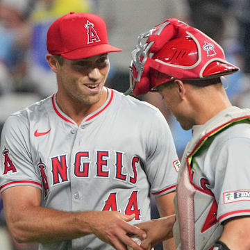 Aug 20, 2024; Kansas City, Missouri, USA; Los Angeles Angels pitcher Ben Joyce (44) celebrates with center fielder Kevin Pillar (12) after the win over the Kansas City Royals at Kauffman Stadium. 