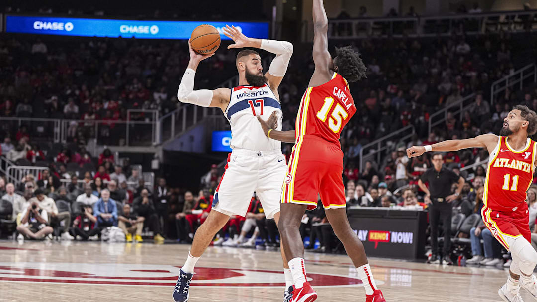 Oct 28, 2024; Atlanta, Georgia, USA; Washington Wizards center Jonas Valanciunas (17) tries to pass defended by Atlanta Hawks center Clint Capela (15) during the first half at State Farm Arena. Mandatory Credit: Dale Zanine-Imagn Images