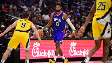 Mar 25, 2024; Los Angeles, California, USA; Los Angeles Clippers forward Paul George (13) moves the ball against Indiana Pacers guard T.J. McConnell (9) during the second half at Crypto.com Arena. Mandatory Credit: Gary A. Vasquez-Imagn Images