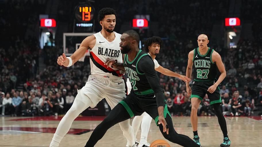 Boston Celtics guard Jaylen Brown handles the ball against Portland Trail Blazers forward Toumani Camara.