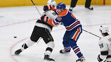 Apr 14, 2025; Edmonton, Alberta, CAN; Los Angeles Kings defenseman Brandt Clarke (92) tangles with Edmonton Oilers right winger Corey Perry (90) during the second period at Rogers Place. Mandatory Credit: Walter Tychnowicz-Imagn Images