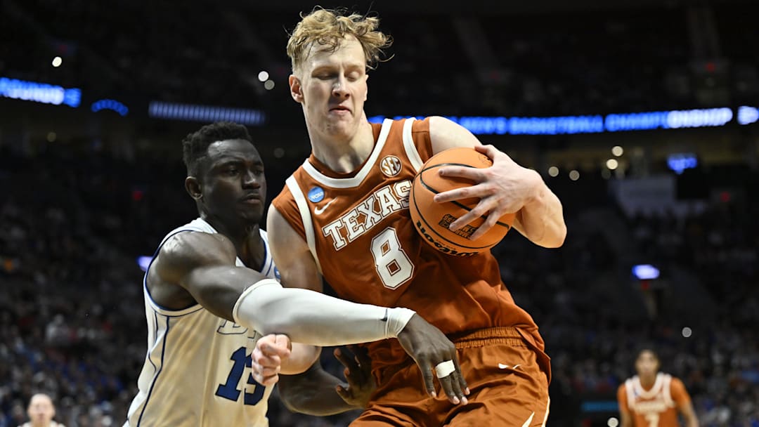 Mar 19, 2026; Portland, OR, USA; Texas Longhorns center Matas Vokietaitis (8) keeps the ball from BYU Cougars center Keba Keita (13) during the first round of the NCAA Tournament.