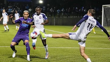 Apr 25, 2023; Matthews, NC, USA; South Georgia Tormenta midfielder Jackson Khoury (11) kicks the ball away from Charlotte FC forward Enzo Copetti (9) during the second half at Mecklenburg County Sportsplex. Mandatory Credit: Jim Dedmon-Imagn Images