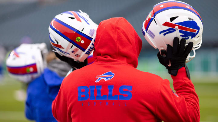 Nov 26, 2023; Philadelphia, Pennsylvania, USA; Buffalo Bills staff members carry helmets onto he