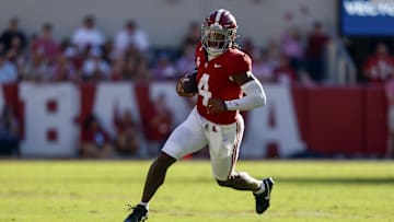 Oct 26, 2024; Tuscaloosa, Alabama, USA;  Alabama Crimson Tide quarterback Jalen Milroe (4) carries the ball for a first down against the Missouri Tigers during the first half at Bryant-Denny Stadium. Mandatory Credit: Butch Dill-Imagn Images