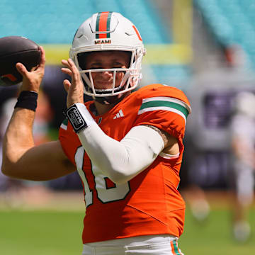 Sep 14, 2024; Miami Gardens, Florida, USA; Miami Hurricanes quarterback Reese Poffenbarger (16) throws the football before the game against the Ball State Cardinals at Hard Rock Stadium. Mandatory Credit: Sam Navarro-Imagn Images