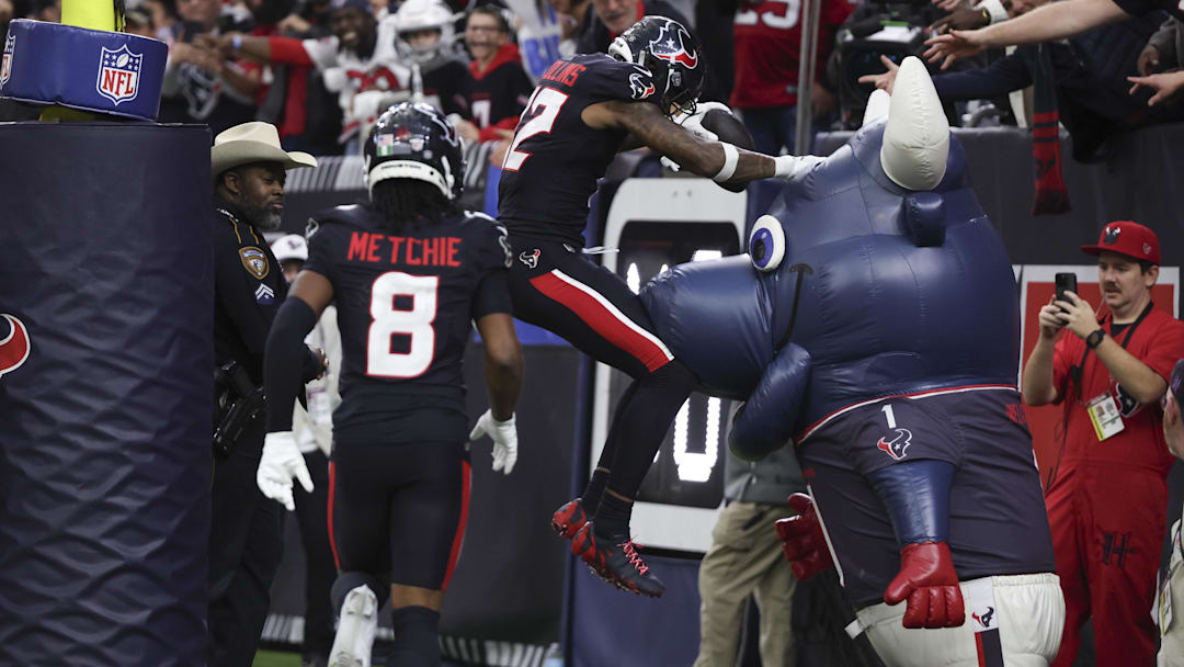 Jan 11, 2025; Houston, Texas, USA;  Houston Texans wide receiver Nico Collins (12) scores a touchdown against the Los Angeles Chargers in the second quarter in an AFC wild card game at NRG Stadium. Mandatory Credit: Thomas Shea-Imagn Images