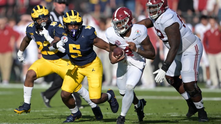 Jan 1, 2024; Pasadena, CA, USA; Alabama Crimson Tide quarterback Jalen Milroe (4) is chased by Michigan Wolverines defensive end Josaiah Stewart (5) during the first half in the 2024 Rose Bowl college football playoff semifinal game at Rose Bowl. Mandatory Credit: Jayne Kamin-Oncea-USA TODAY Sports