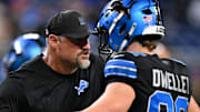 Detroit Lions head coach Dan Campbell reacts with tight end Ross Dwelley (82) before Buccaneers game