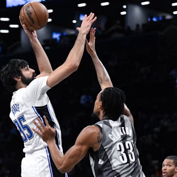 Dec 1, 2024; Brooklyn, New York, USA; Orlando Magic center Goga Bitadze (35) shoots the ball while being defended by Brooklyn Nets center Nic Claxton (33) during the first half at Barclays Center. Mandatory Credit: John Jones-Imagn Images
