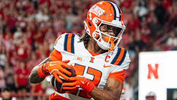 Sep 20, 2024; Lincoln, Nebraska, USA; Illinois Fighting Illini wide receiver Pat Bryant (13) scores a touchdown in overtime against the Nebraska Cornhuskers at Memorial Stadium. Mandatory Credit: Dylan Widger-Imagn Images