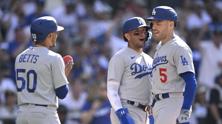 Aug 6, 2023; San Diego, California, USA; Los Angeles Dodgers first baseman Freddie Freeman (5) is congratulated by shortstop Miguel Rojas (11) and right fielder Mookie Betts (50) after hitting a two-run home run during the second inning against the San Diego Padres at Petco Park. Mandatory Credit: Orlando Ramirez-USA TODAY Sports