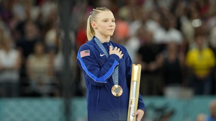 Aug 3, 2024; Paris, France; Jade Carey of the United States during the national anthem with her bronze medal during the medal ceremony for the vault on the first day of gymnastics event finals during the Paris 2024 Olympic Summer Games at Bercy Arena. Mandatory Credit: Kyle Terada-USA TODAY Sports