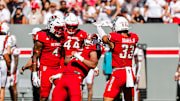 Oct 4, 2025; Raleigh, North Carolina, USA;  NC State Wolfpack defensive end Sabastian Harsh (54) and linebacker Jr. Kenny Soares (33) celebrate a tackle during the first half of the game against Campbell Fighting Camels at Carter-Finley Stadium. Mandatory Credit: Jaylynn Nash-Imagn Images