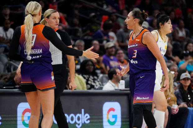 Phoenix Mercury players Diana Taurasi and Sophie Cunningham talk to an official in a game against the Sparks. 