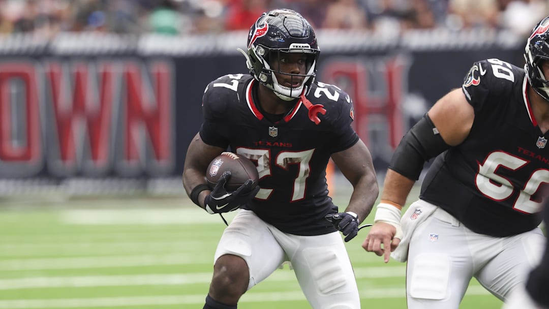 Sep 28, 2025; Houston, Texas, USA; Houston Texans running back Woody Marks (27) runs with the ball during the fourth quarter against the Tennessee Titans at NRG Stadium. Mandatory Credit: Troy Taormina-Imagn Images