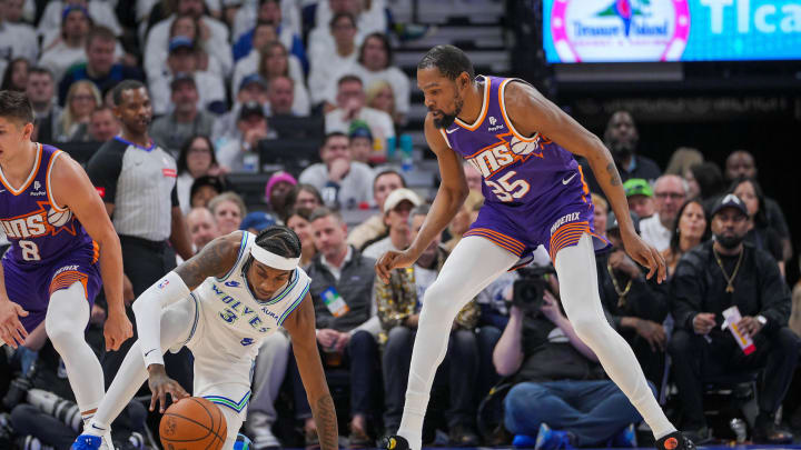 Apr 23, 2024; Minneapolis, Minnesota, USA; Phoenix Suns forward Kevin Durant (35) defends the Minnesota Timberwolves forward Jaden McDaniels (3) in the second quarter during game two of the first round for the 2024 NBA playoffs at Target Center. Mandatory Credit: Brad Rempel-USA TODAY Sports