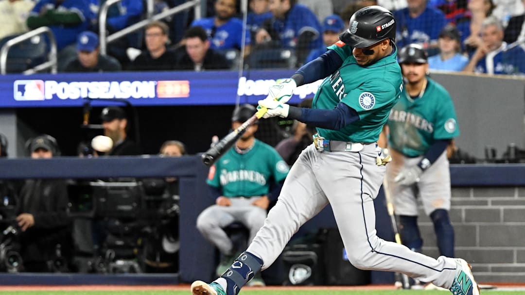 Oct 13, 2025; Toronto, Ontario, CAN; Seattle Mariners second baseman Jorge Polanco (7) hits a single against the Toronto Blue Jays in the seventh inning during game two of the ALCS round for the 2025 MLB playoffs at Rogers Centre. Mandatory Credit: Dan Hamilton-Imagn Images