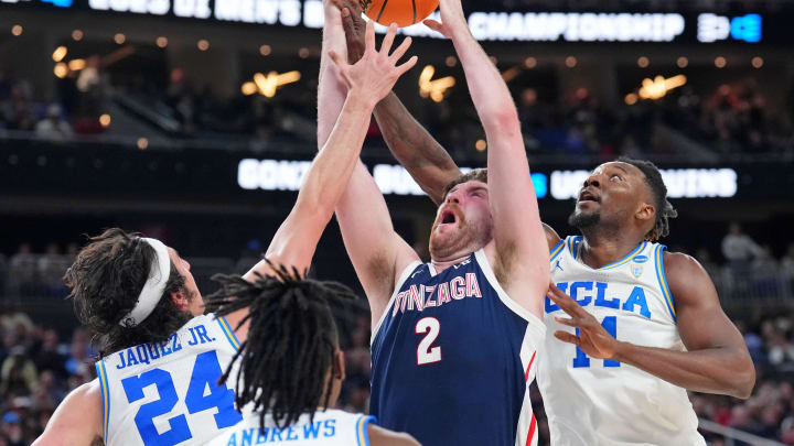 Mar 23, 2023; Las Vegas, NV, USA; Gonzaga Bulldogs forward Drew Timme (2) reaches for a loose ball against UCLA Bruins guard Jaime Jaquez Jr. (24) and forward Kenneth Nwuba (14) during the first half at T-Mobile Arena. Mandatory Credit: Joe Camporeale-USA TODAY Sports