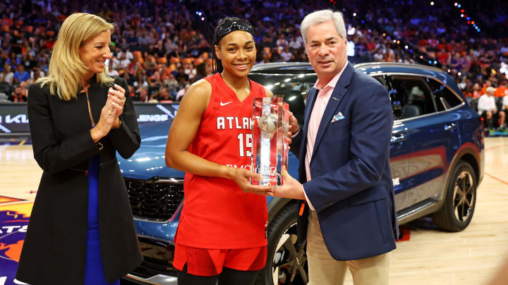 Atlanta Dream player Allisha Gray is presented with the trophy for winning the skills challenge