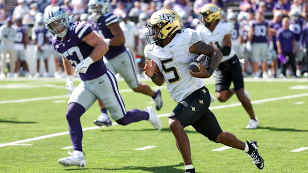 UCF Knights running back Jaden Nixon (5) tries to run from Kansas State Wildcats linebacker Beau Palmer (57) 