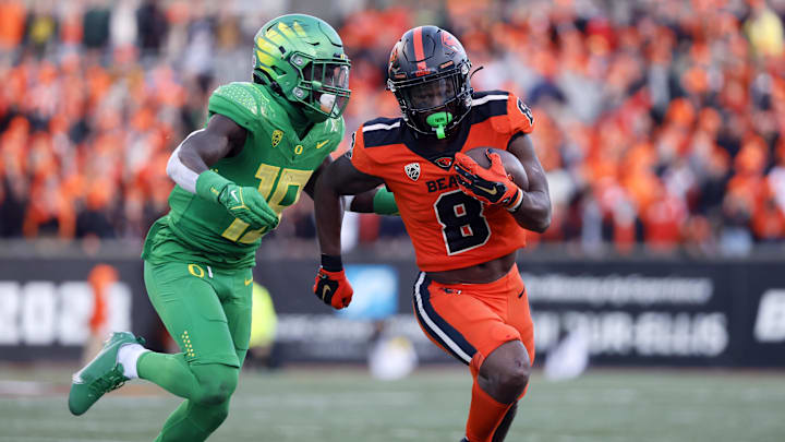 Nov 26, 2022; Corvallis, Oregon, USA; Oregon State Beavers running back Jam Griffin (8) runs the ball against Oregon Ducks linebacker Mase Funa (18) during the second half at Reser Stadium. Mandatory Credit: Soobum Im-Imagn Images